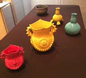 Five Caddo designed pots in bright yellow, red, turquoise, and purple
